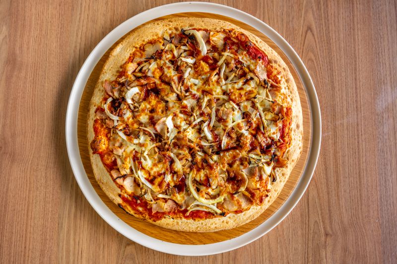 Traditional marco pizza preparation with fresh toppings